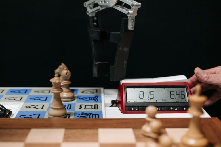 Robotic arm moves chess pieces on a board with electronic digital timer displayed.